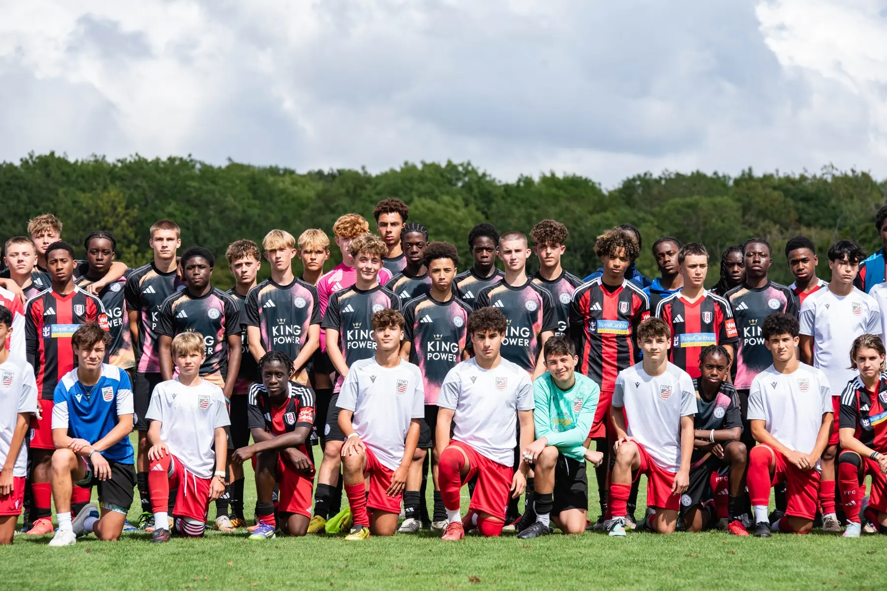 Players and staff from several teams together after the football festival