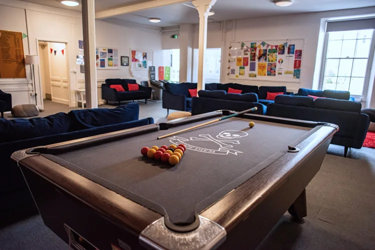 Residential common room with sofas and a pool table