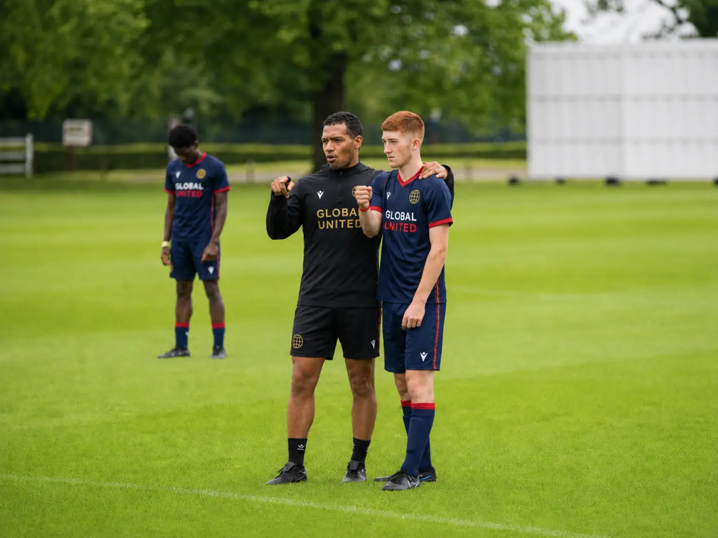 A coach giving detailed guidance to a Global United player